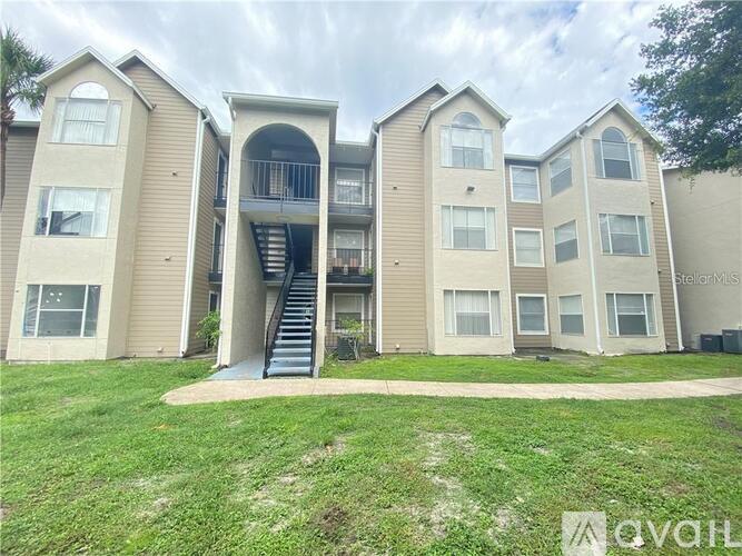 Apartment complex with a grassy area in front.