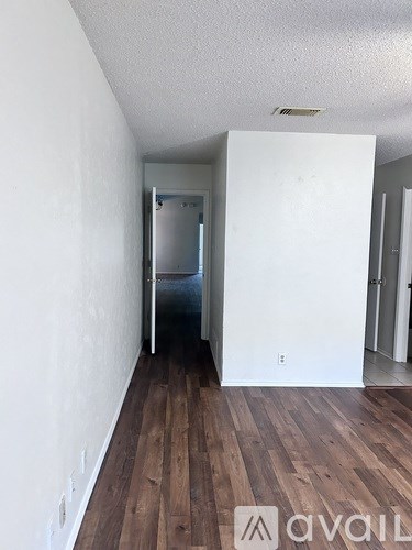 A room with wooden floors and white walls.