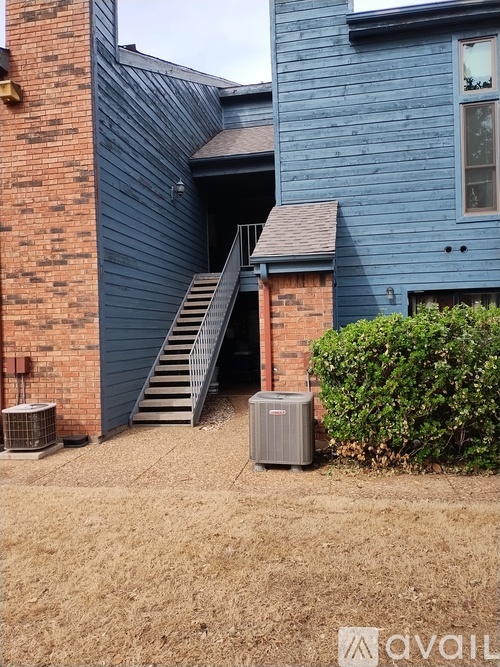 A house with a blue exterior and a brick chimney.