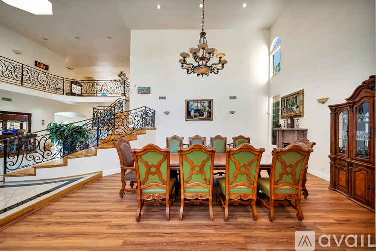 A dining room with a wooden table and chairs.