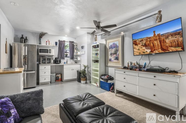 A modern living room with a large TV displaying a desert landscape.