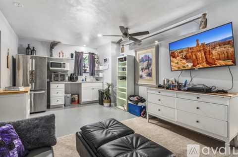 A modern living room with a large TV displaying a desert landscape.