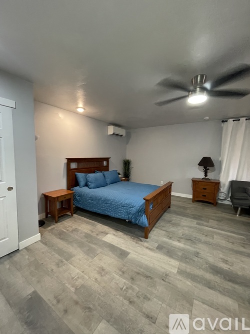 A living room with a flat screen TV mounted on the wall.