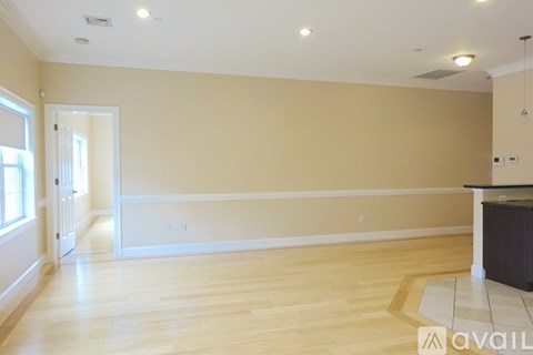 A room with wooden floors and a large empty space.
