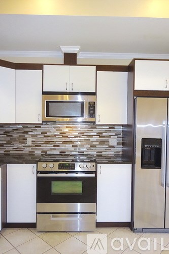 A kitchen with a stove top oven and a microwave above it.