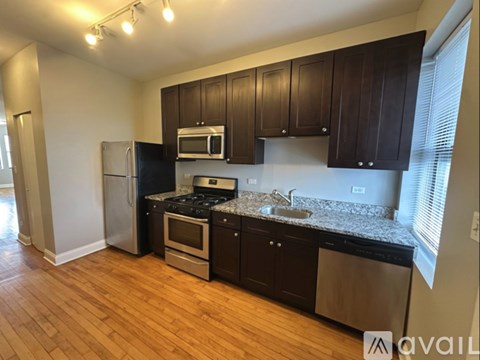 A kitchen with wooden cabinets and stainless steel appliances.