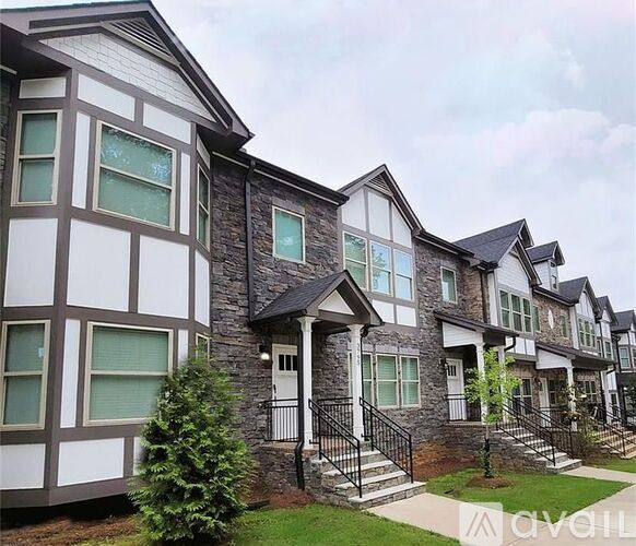 A row of houses with a tree in front of the first one.