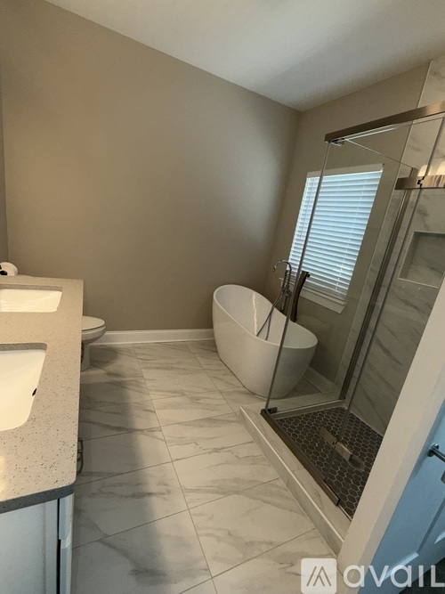 A bathroom with a walk-in shower and a toilet.