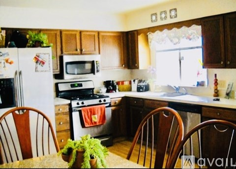 A kitchen with wooden cabinets and a white refrigerator.