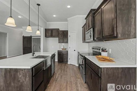 A modern kitchen with dark wood cabinets and a white countertop.