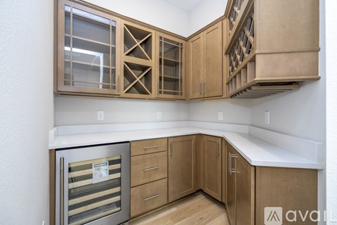 A kitchen with wooden cabinets and a stainless steel oven.