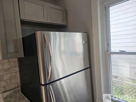 A stainless steel refrigerator is in a kitchen.