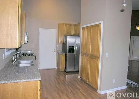 A kitchen with wooden cabinets and a granite countertop.