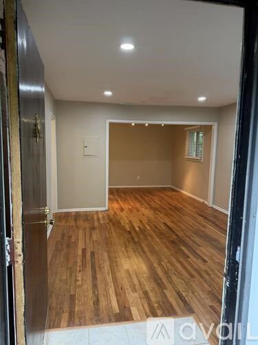 A room with wooden flooring and a white ceiling.
