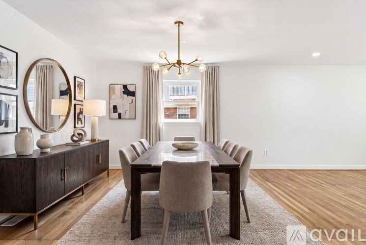 A dining room with a wooden table and chairs.