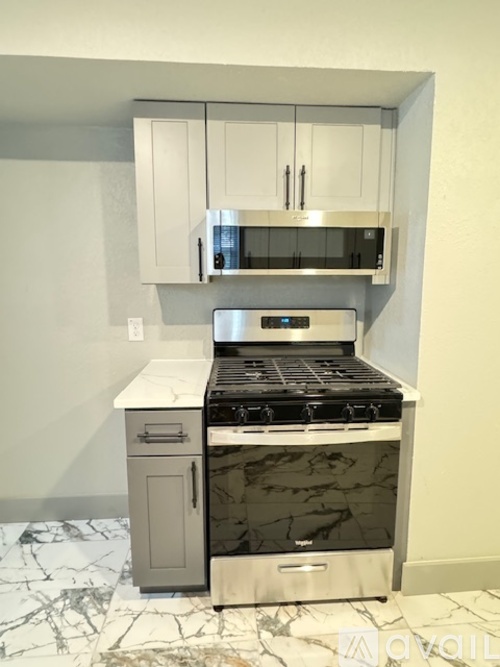 A kitchen with a marble countertop and stove.