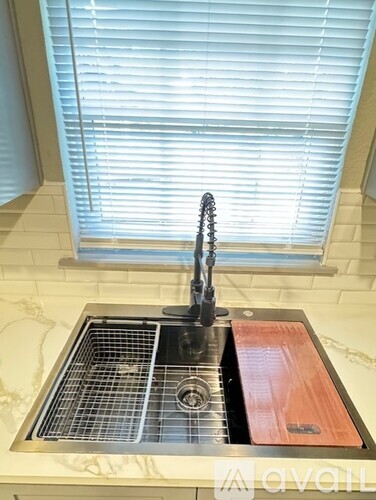A kitchen sink with a red drain board.