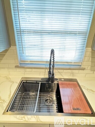 A kitchen sink with a red drain board.