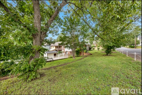 A house is surrounded by greenery and trees.