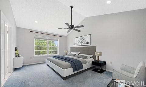 A bedroom with a large bed, a ceiling fan, and a window with blinds.