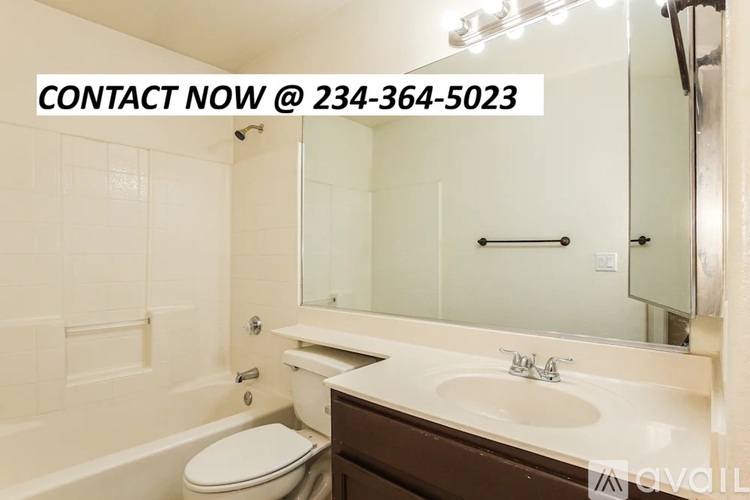 A bathroom with a toilet, sink, and bathtub is shown with a contact number.