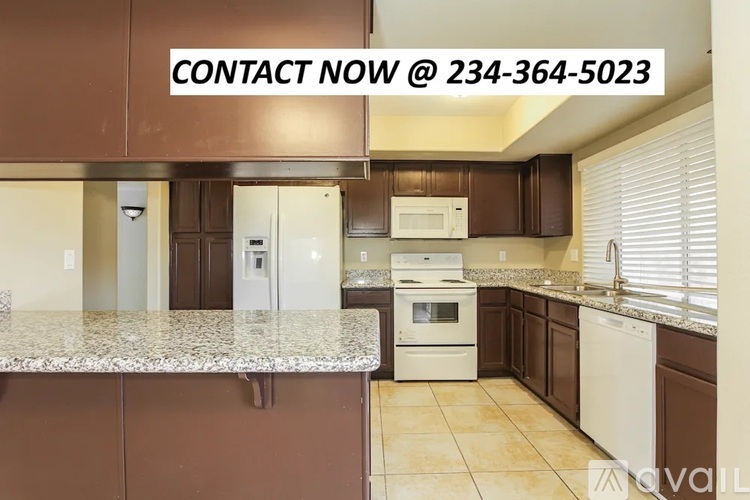 A kitchen with brown cabinets and a granite countertop is on the market.