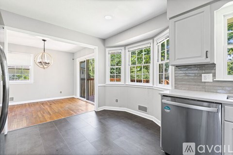 A kitchen with a dishwasher and a chandelier.