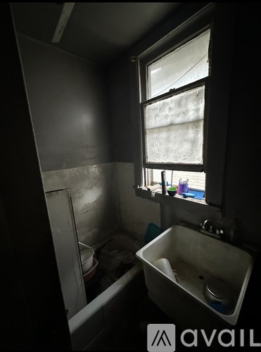 A bathroom with a sink, toilet and window.