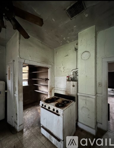 A kitchen with a stove and a fan.