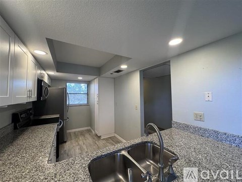A kitchen with a sink and a window.
