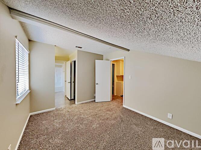 A kitchen with white cabinets and a granite countertop.