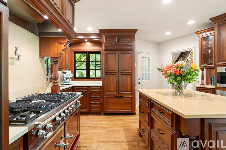 A kitchen with wooden cabinets and a marble countertop.