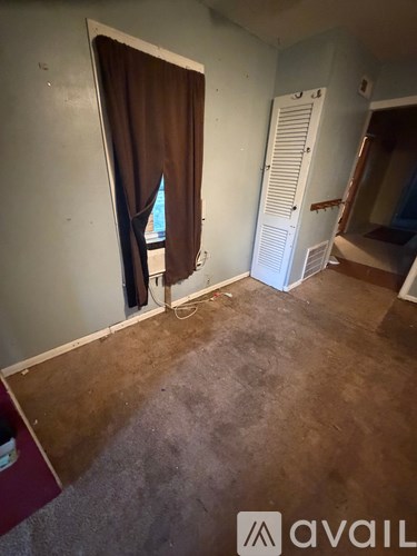 A room with a brown carpet and a white door.