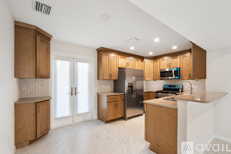 A kitchen with wooden cabinets and stainless steel appliances.