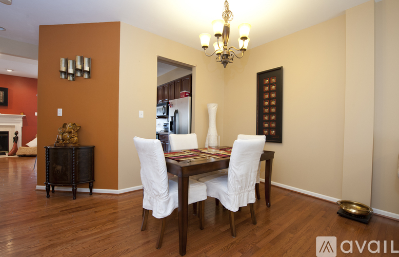 A dining room with a wooden table and chairs.