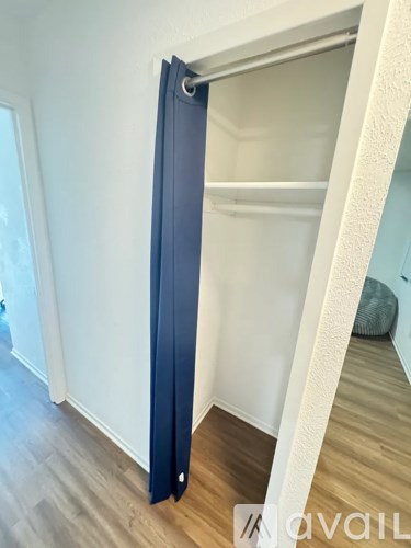 A room with a sliding door and a wooden floor.