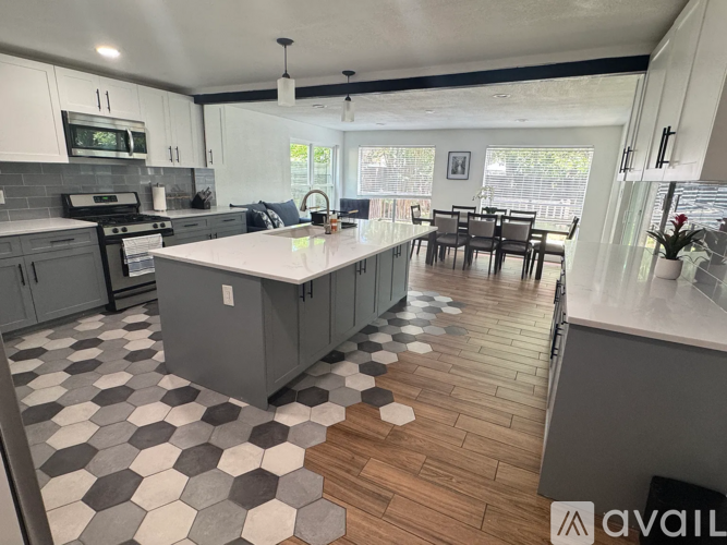 A kitchen with a checkered floor and a dining table.