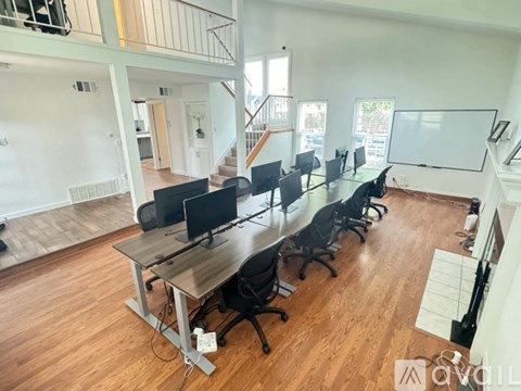 A conference room with a long table and chairs.