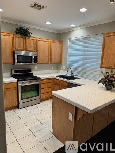 A kitchen with wooden cabinets and a white countertop.