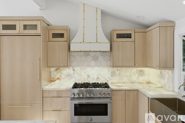 A kitchen with wooden cabinets and a stove top oven.