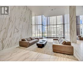 A living room with a marble wall and a large window.