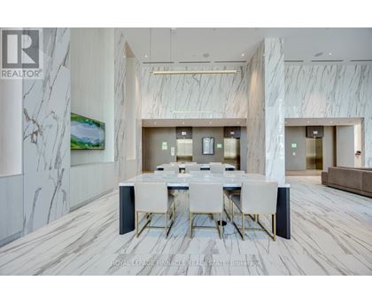A dining room with a marble floor and a white table with chairs.