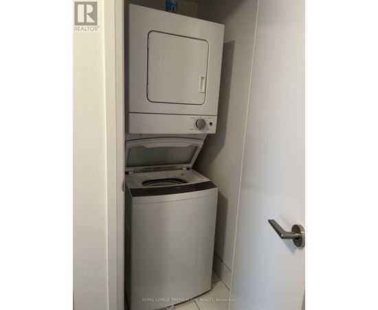 A white door with a handle is open to reveal a white dishwasher.