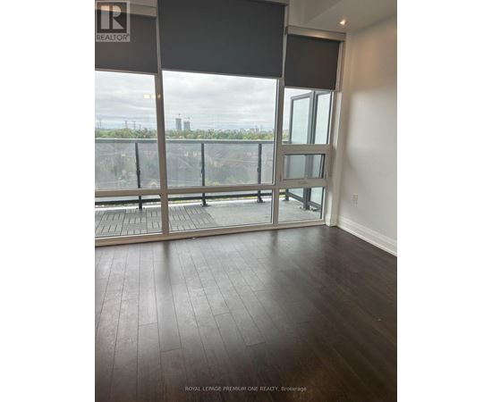A room with a large window and a balcony.