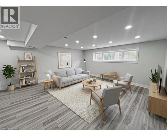 A living room with a grey sofa, a wooden coffee table, and a television.