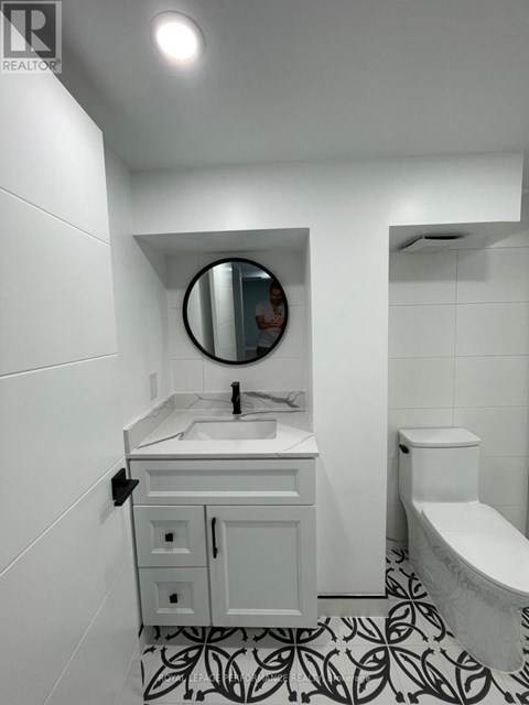A bathroom with a sink, toilet, and bathtub.