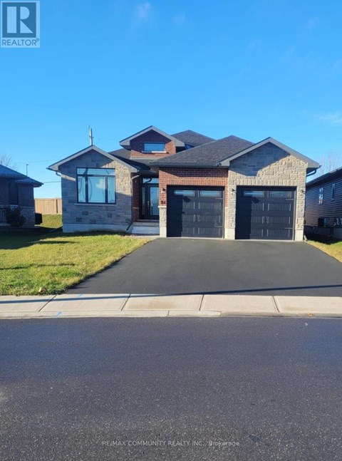 A house with a black garage door is for sale.