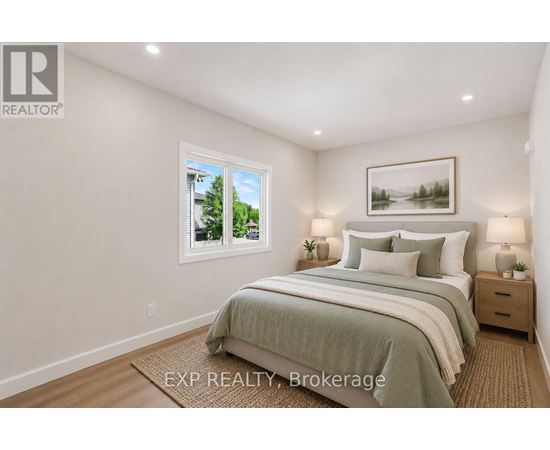 A bedroom with a large bed and a window showing a tree and a house outside.