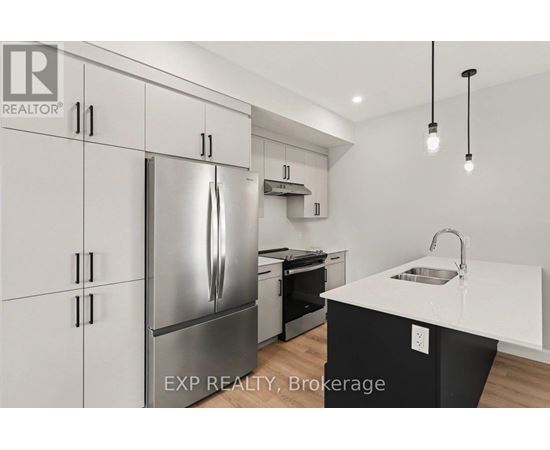 A modern kitchen with a stainless steel refrigerator and a white countertop.