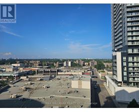 A view of a cityscape from a high vantage point, with a clear blue sky above.